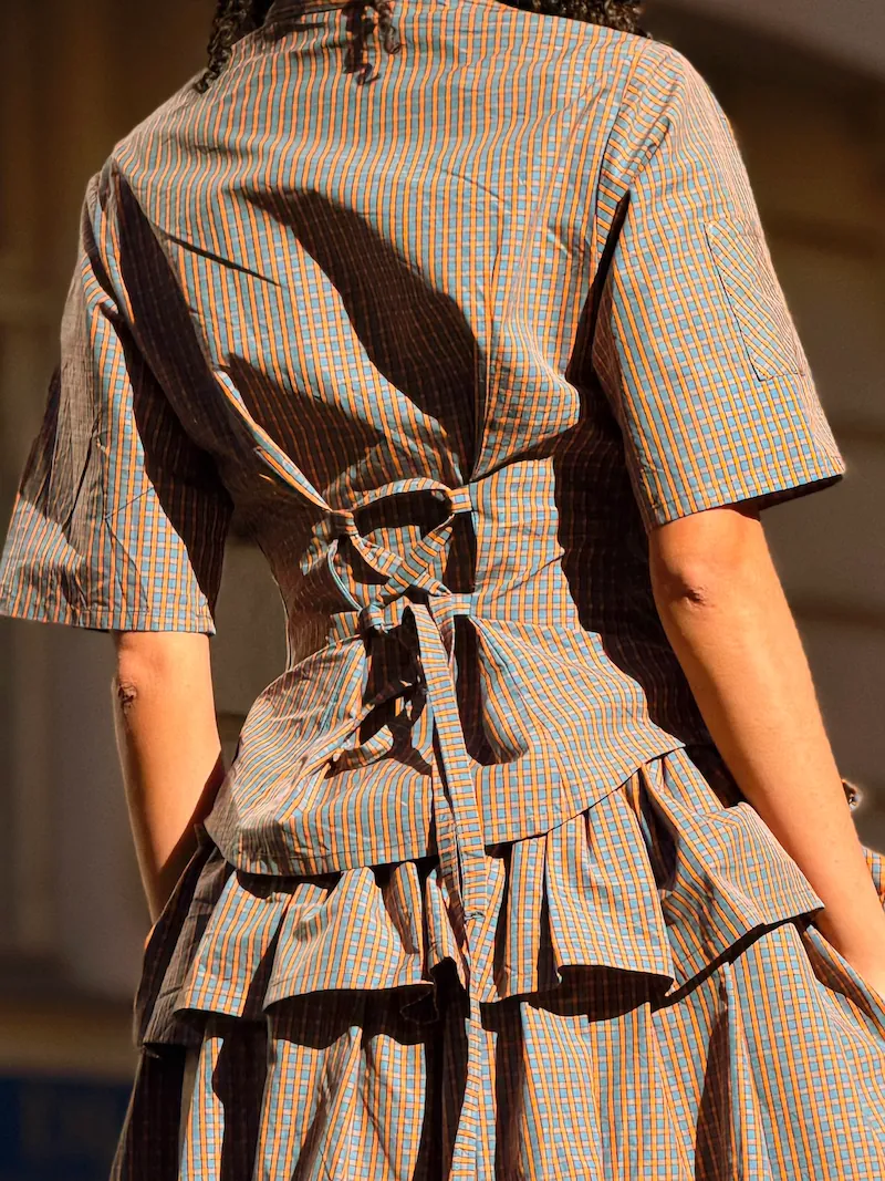 Back detail of Shytrovert handmade corset shirt with adjustable tie — deadstock plaid fabric