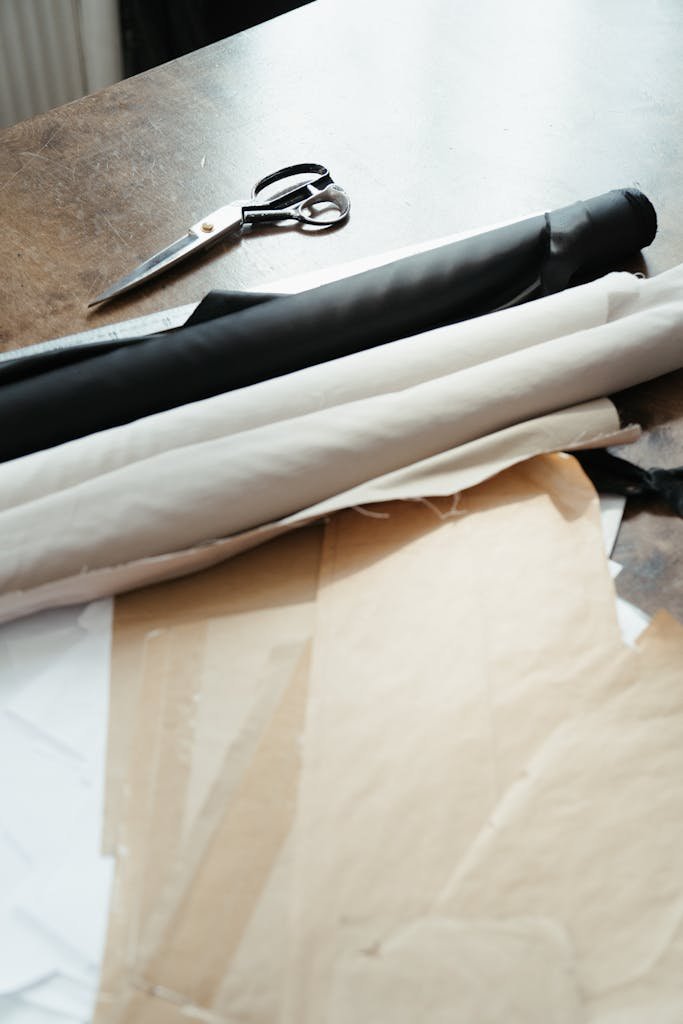 Close-up of neatly arranged fabric and scissors in a textile workshop.